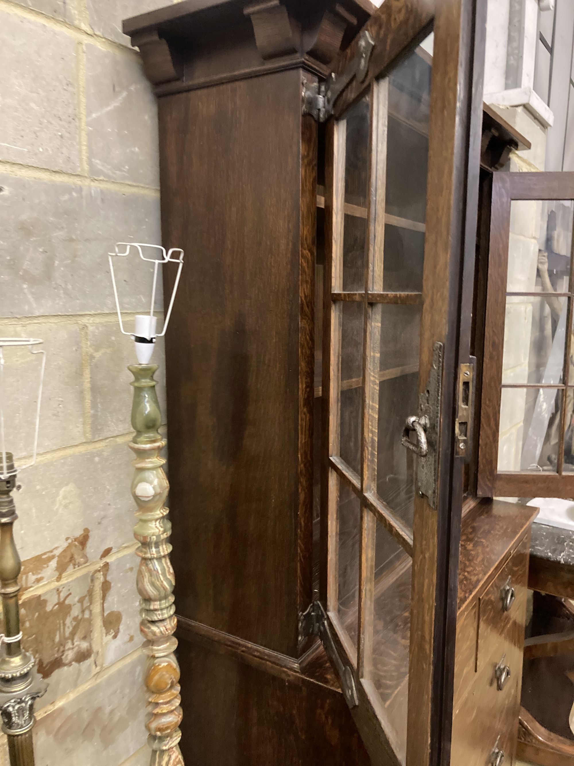 An early 20th century Arts and Crafts oak bookcase on chest, width 114cm, depth 48cm, height 208cm